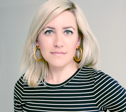 Studio portrait of Brie Code looking at the camera.