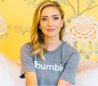 Screenshot of Whitney Wolfe Herd sitting on a sofa.